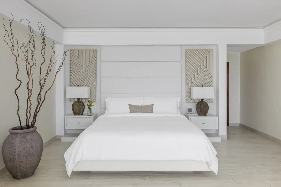 King bed in a Resort View Junior Suite at Aurora Anguilla Resort & Golf Club.