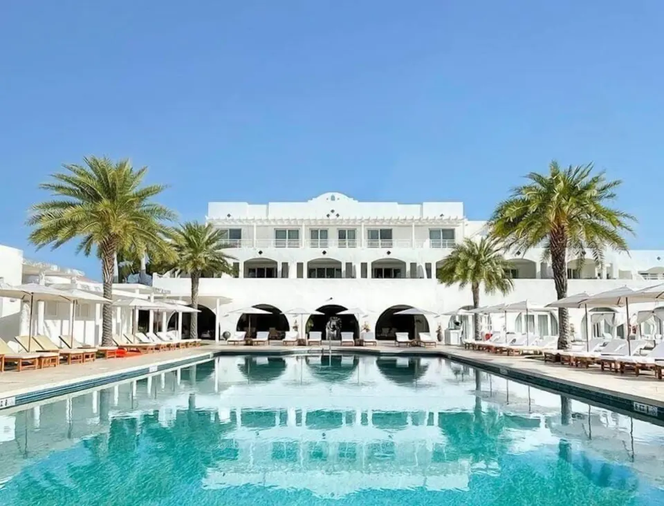 Pool and white resort building at Aurora Anguilla Resort & Golf Club.