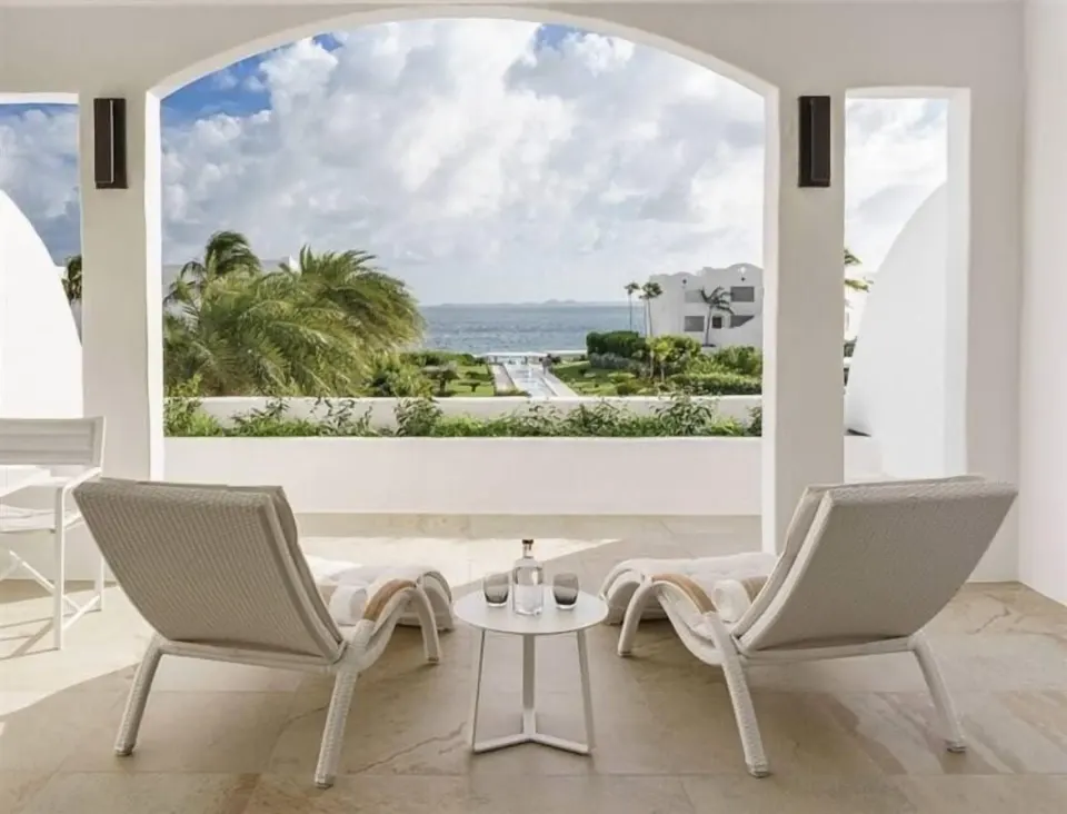 Covered terrace with lounge chairs at Aurora Anguilla Resort & Golf Club.
