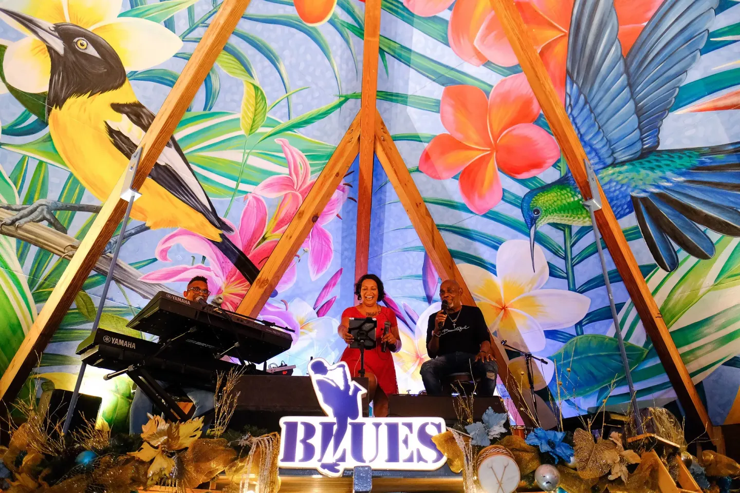 Live music stage with a tropical bird mural at Avila Beach Hotel.
