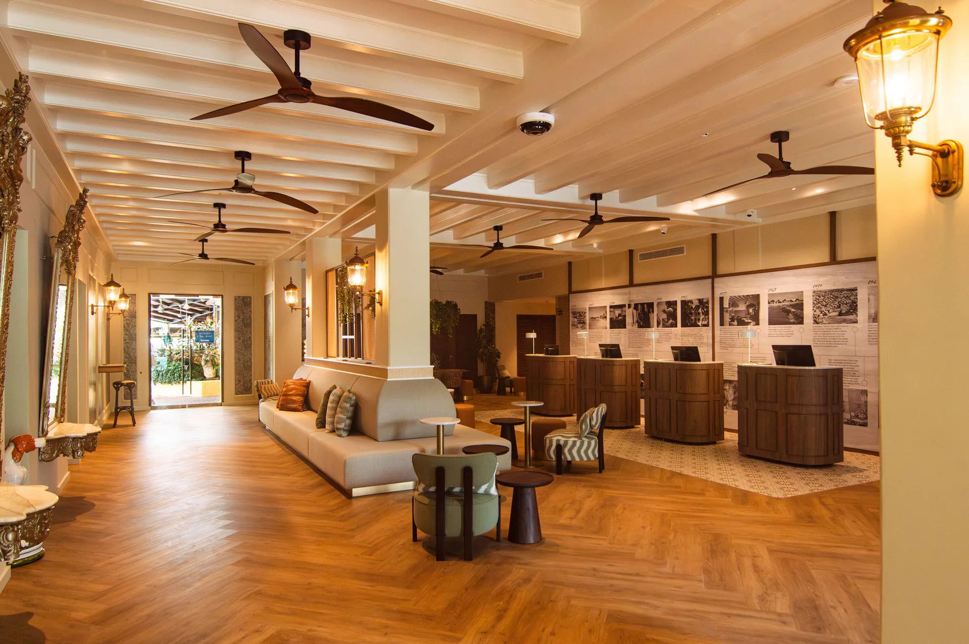 Lobby of Avila Beach Hotel with seating, ceiling fans, reception desks, and warm lighting.