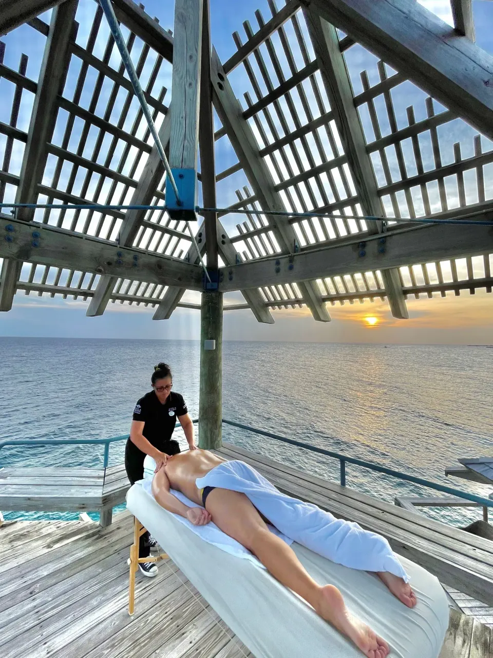 Oceanfront massage under a wooden pavilion at Avila Beach Hotel.