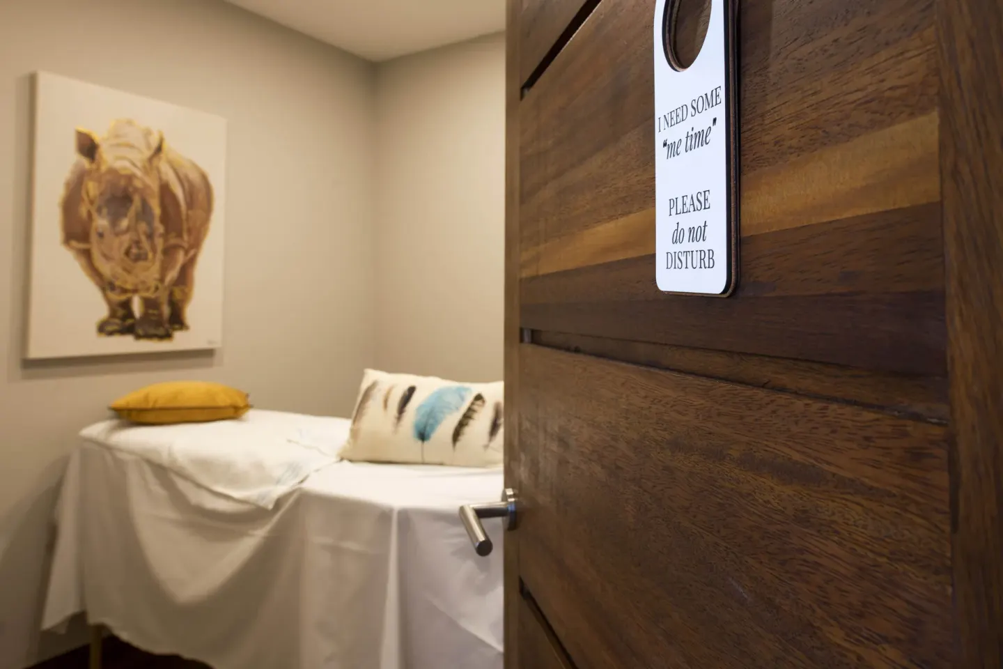 Spa treatment room door with massage bed inside at Avila Beach Hotel.