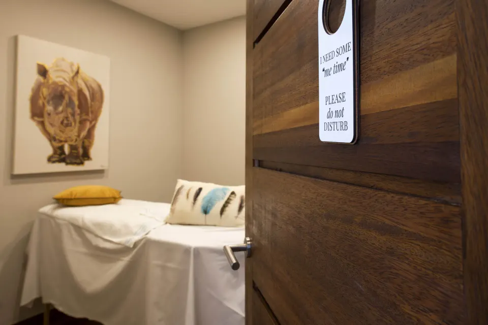 Spa treatment room door with massage bed inside at Avila Beach Hotel.