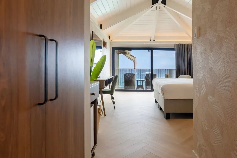Deluxe Oceanfront room entry leading to bed and balcony at Avila Beach Hotel.