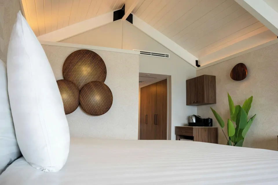 Deluxe Oceanfront guest room bed and vaulted ceiling at Avila Beach Hotel.