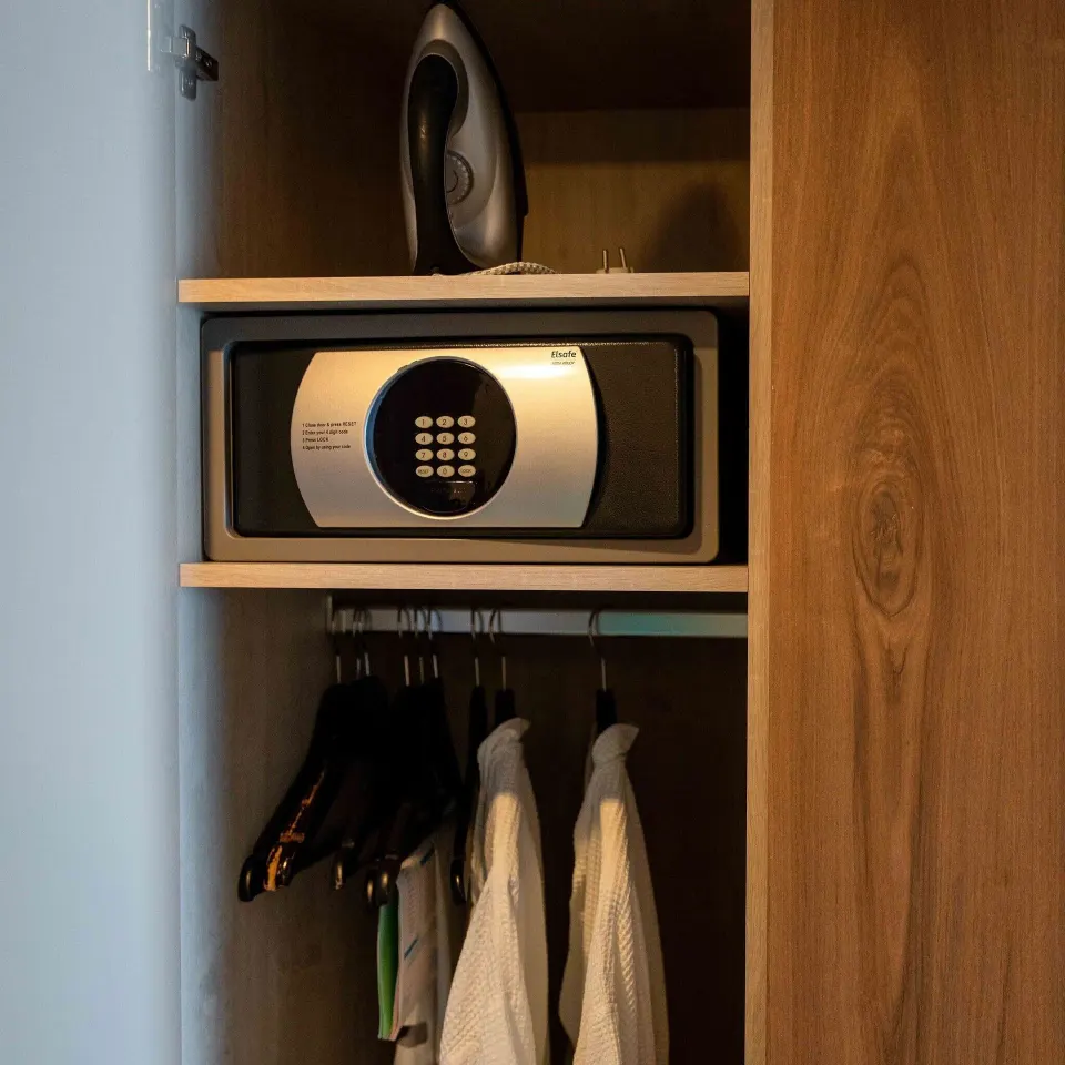 Wardrobe safe, iron, robes, and hangers in a Deluxe Oceanfront Room at Avila Beach Hotel.