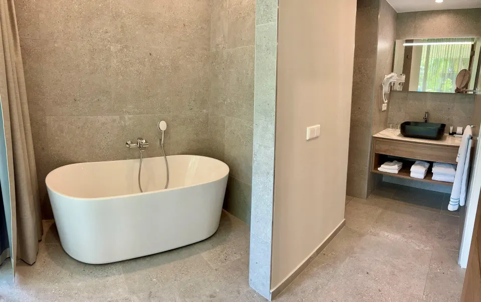 Deluxe Room bathroom with freestanding tub and vanity at Avila Beach Hotel.