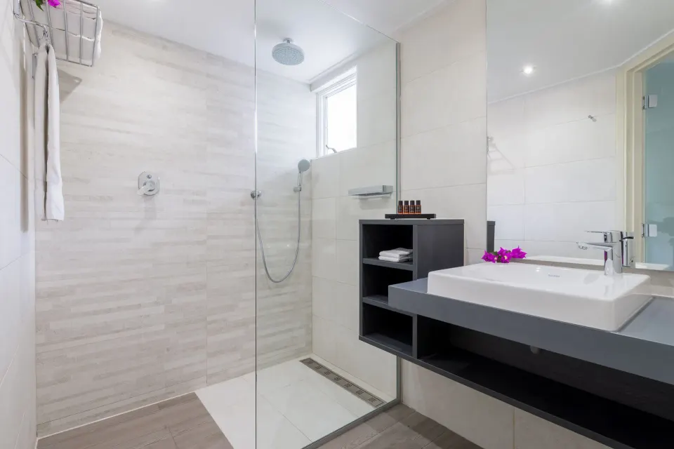 Bathroom shower and vanity in la Belle Alliance apartment at Avila Beach Hotel.