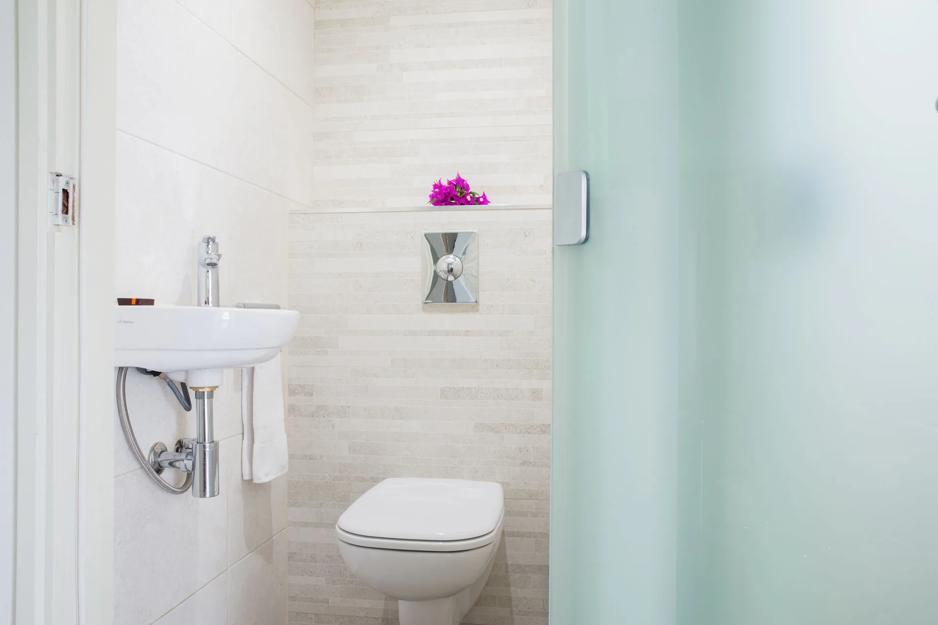 Bathroom toilet and small sink in la Belle Alliance apartment at Avila Beach Hotel.