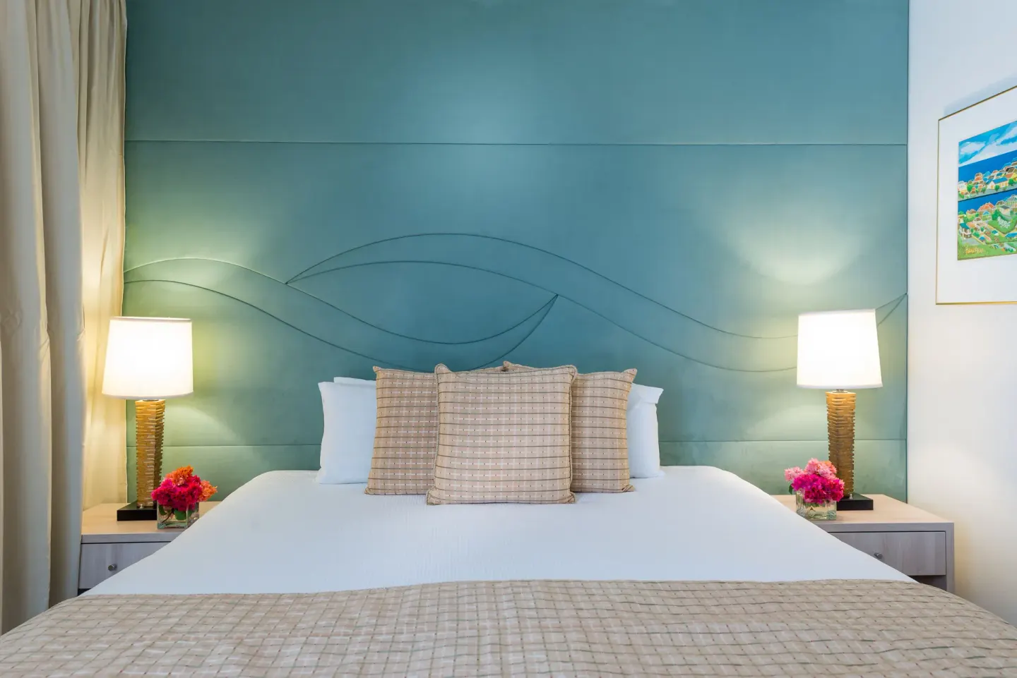King bed in la Belle Alliance one-bedroom apartment at Avila Beach Hotel with teal headboard.