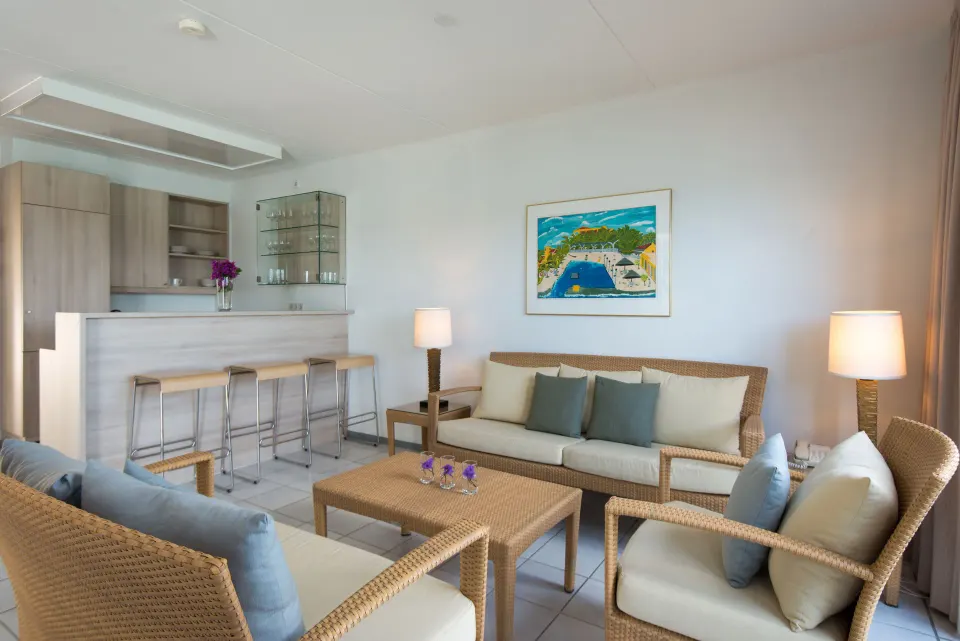 Living room of la Belle Alliance one-bedroom apartment at Avila Beach Hotel with sofa and bar seating.