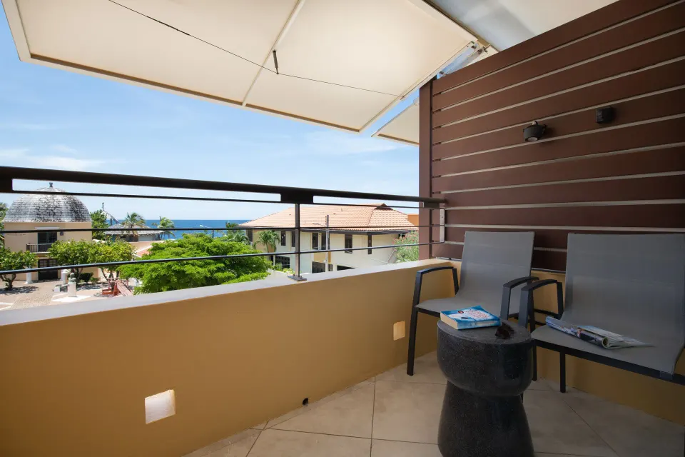 Preferred Room balcony with two chairs and ocean glimpses at Avila Beach Hotel.
