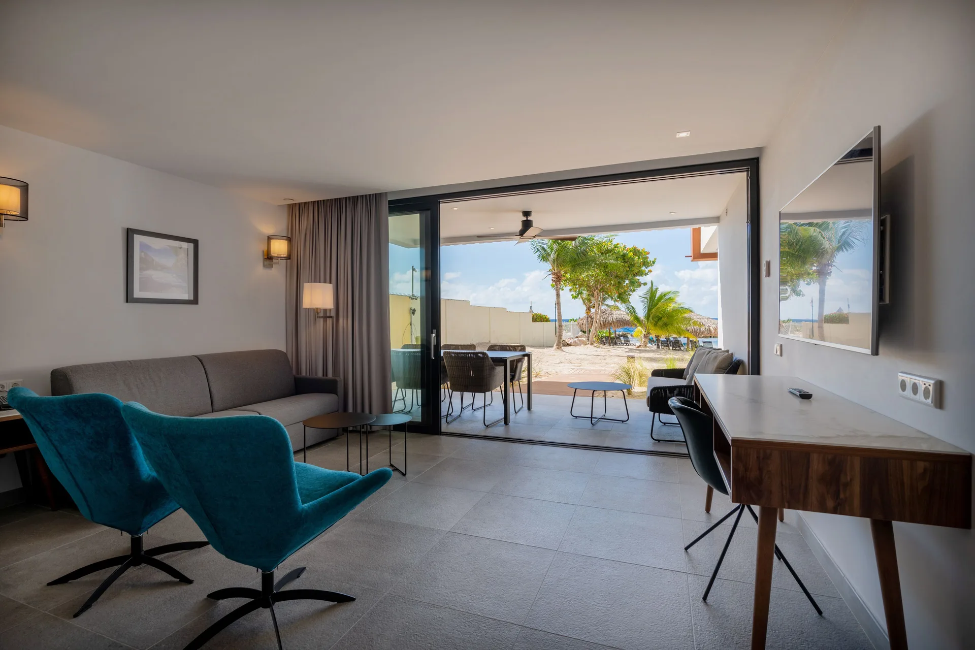 Beachfront apartment living room with patio and ocean view at Avila Beach Hotel.