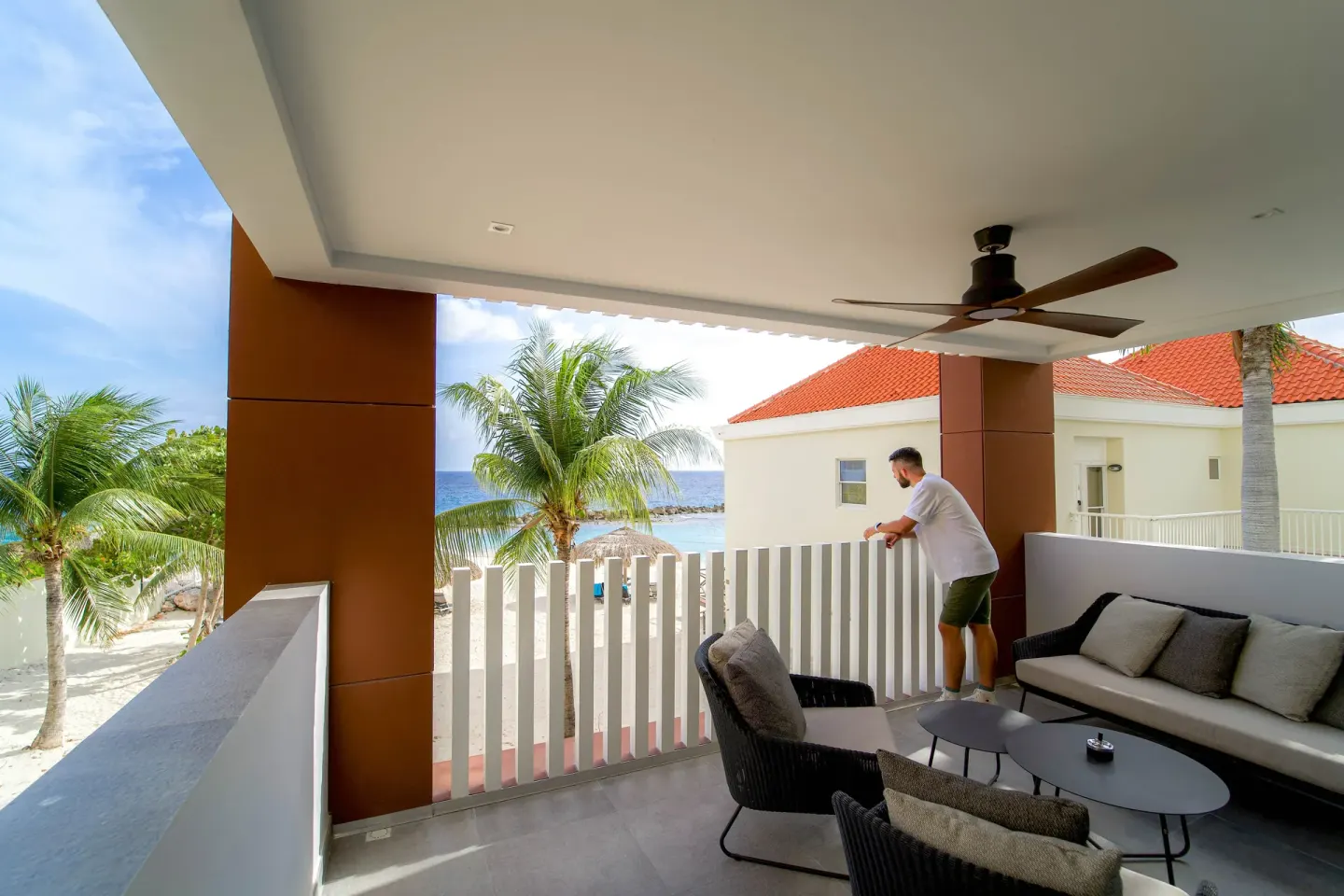 Premium apartment covered balcony with seating and ocean view at Avila Beach Hotel.