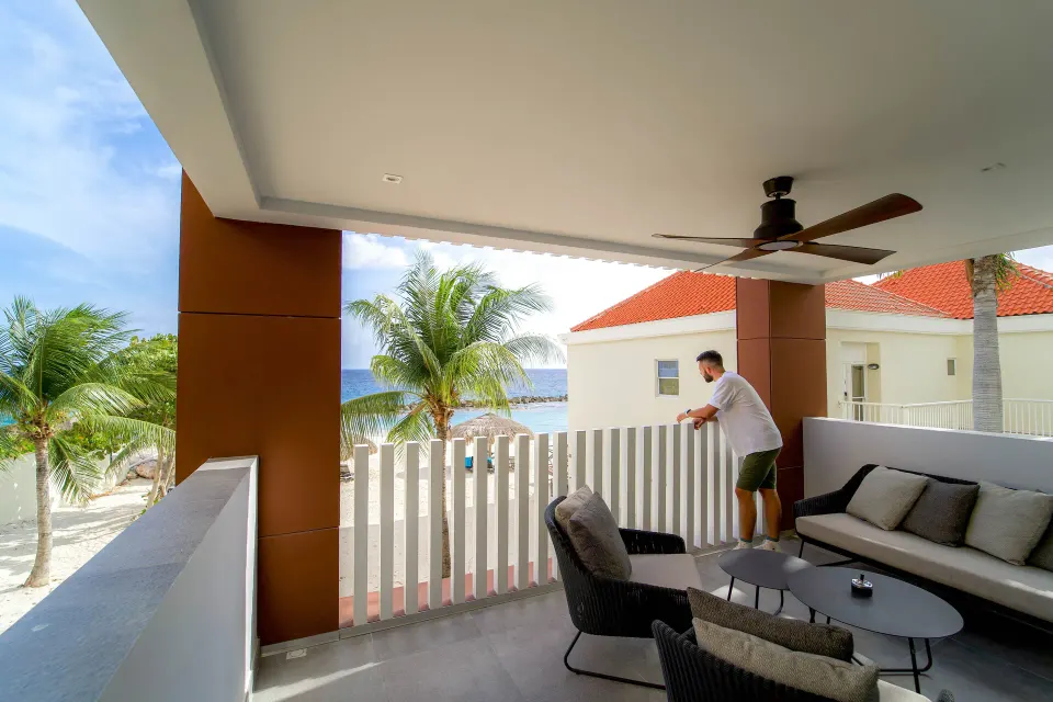 Premium apartment covered balcony with seating and ocean view at Avila Beach Hotel.