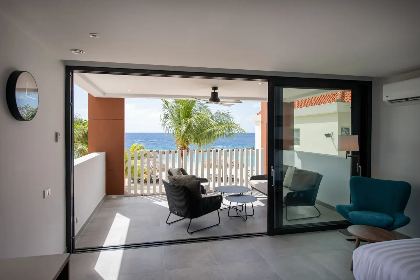 Premium apartment bedroom looking onto a balcony and ocean at Avila Beach Hotel.
