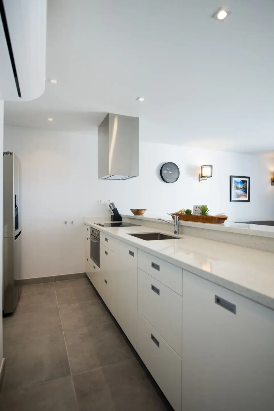 Premium apartment kitchen with white cabinetry and sink at Avila Beach Hotel.