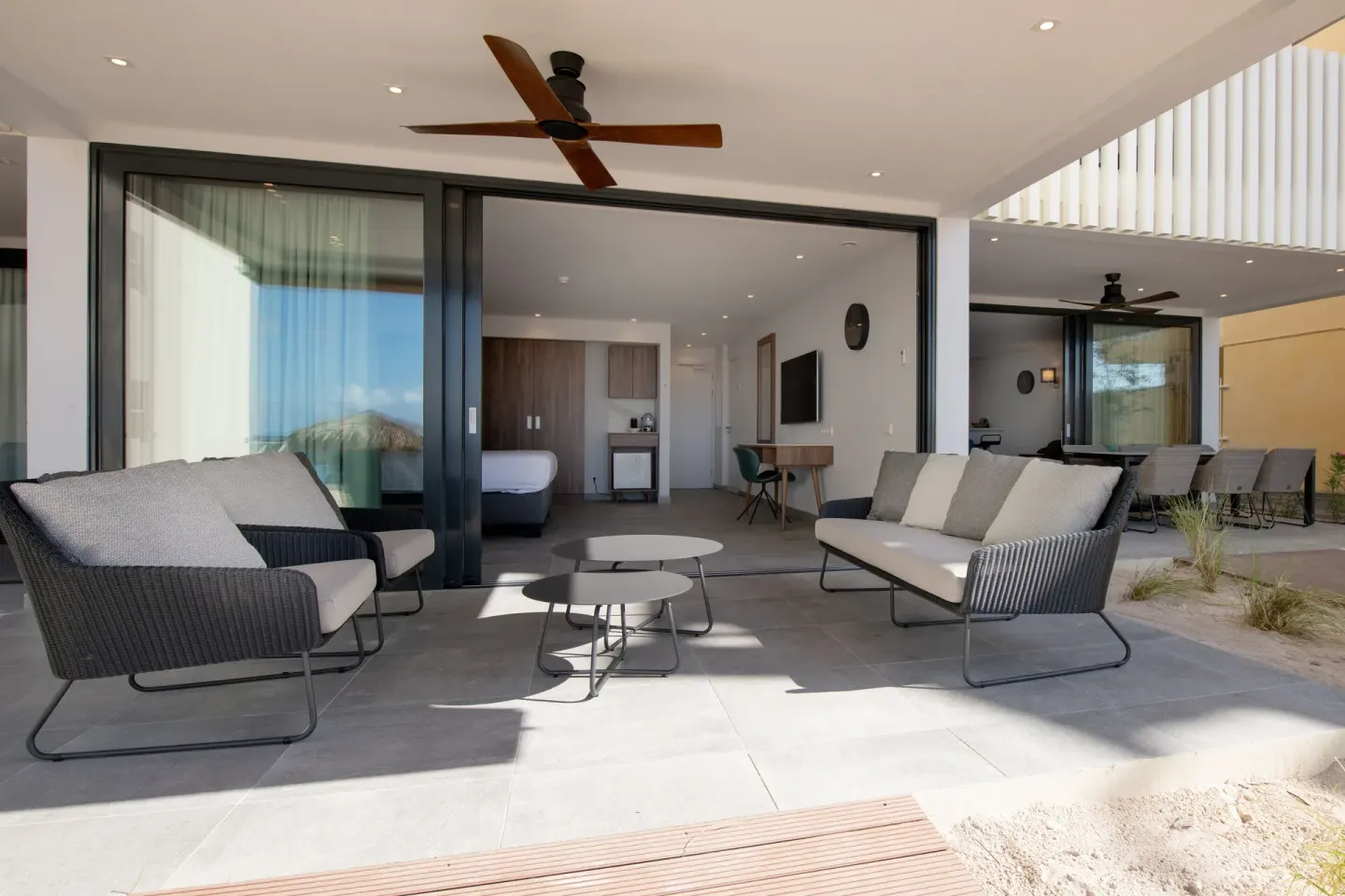 Beachfront premium apartment terrace with seating outside a bedroom at Avila Beach Hotel.