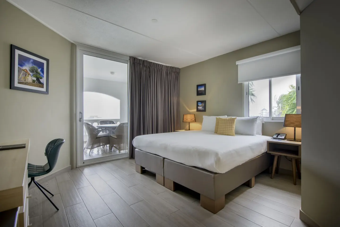 Royal Three Bedroom Apartment bedroom with balcony door at Avila Beach Hotel.