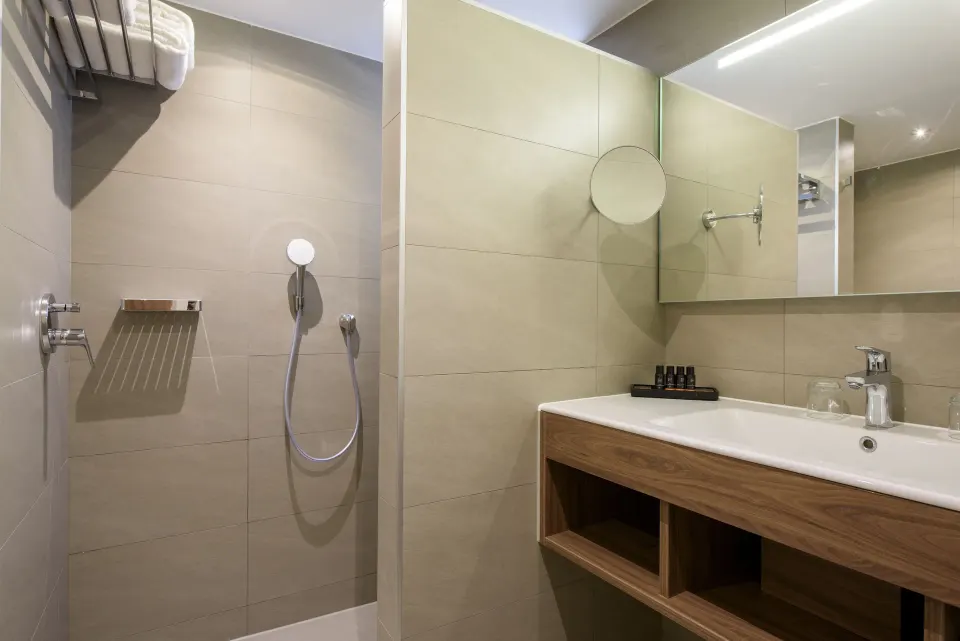 Standard Room bathroom with walk-in shower and vanity at Avila Beach Hotel.