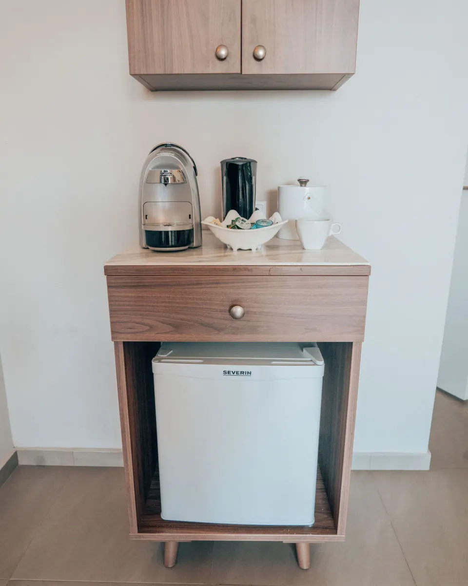 Standard Room refreshment station with mini fridge and coffee maker at Avila Beach Hotel.