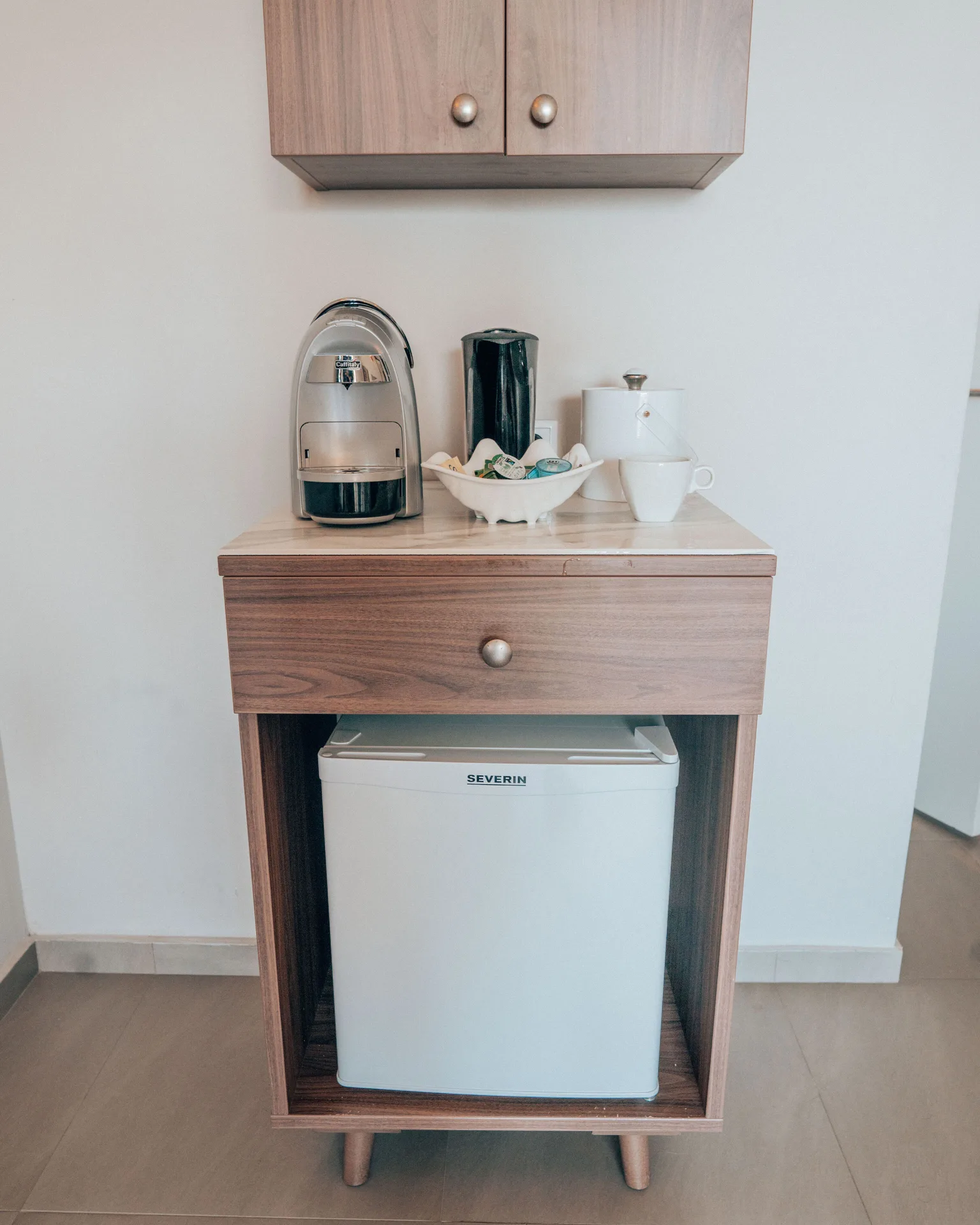 Standard Room refreshment station with mini fridge and coffee maker at Avila Beach Hotel.