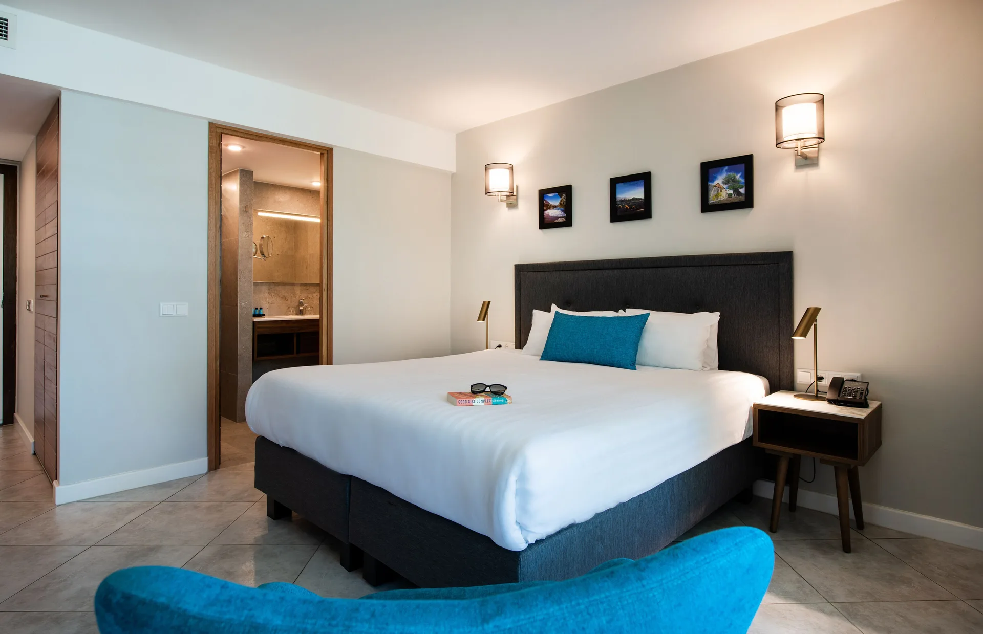 Standard Room king bed with bedside tables and open bathroom at Avila Beach Hotel.