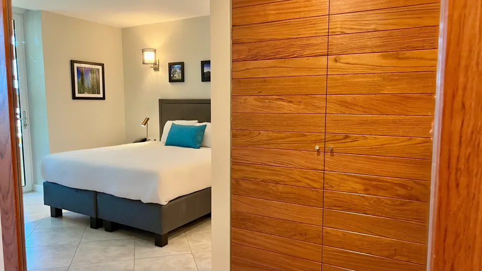 Standard Room king bed and wood wardrobe at Avila Beach Hotel.