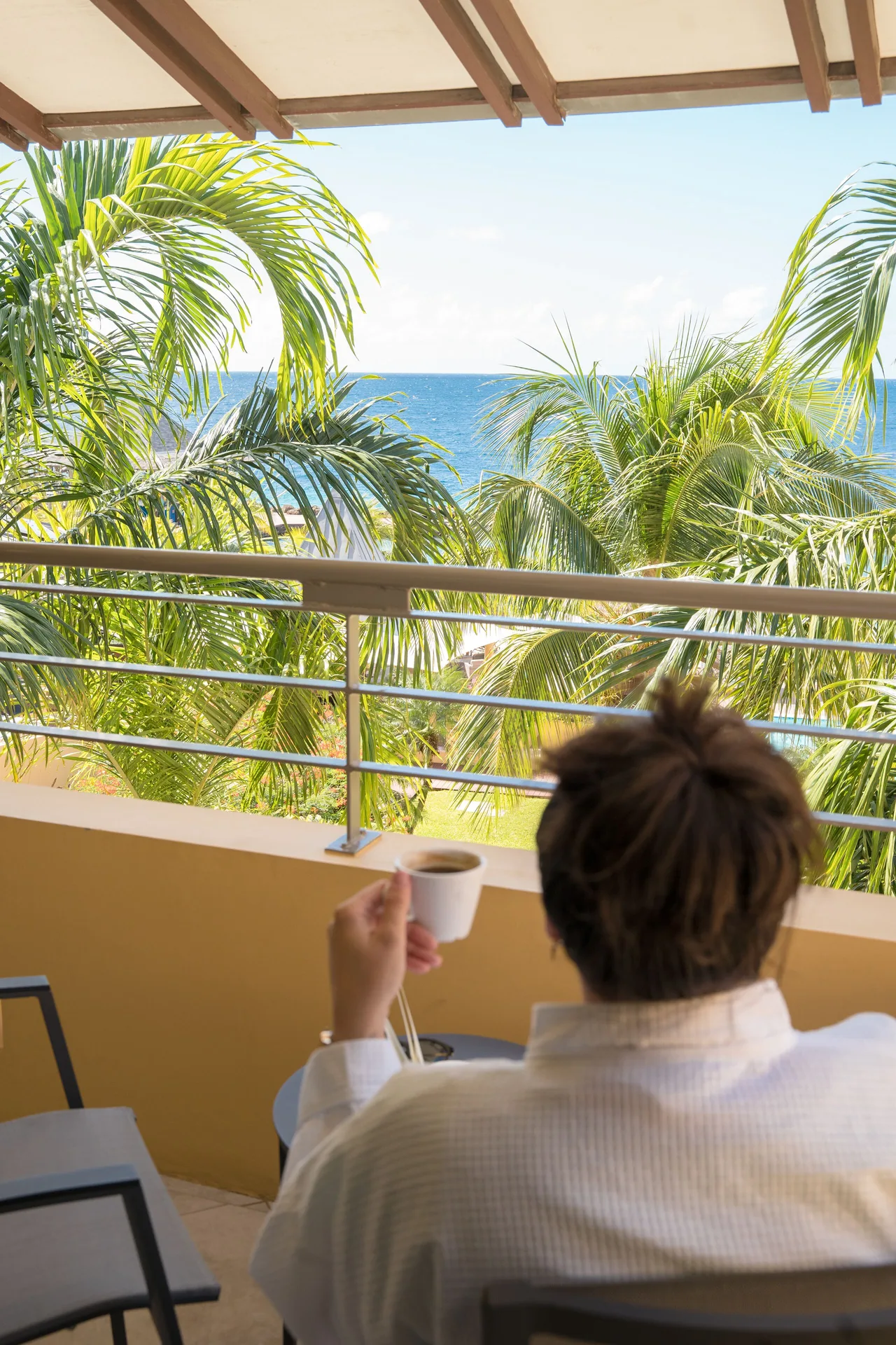 Standard Room octagon balcony ocean view with palm trees at Avila Beach Hotel.