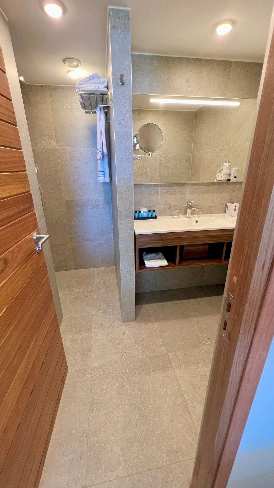 Standard Room octagon bathroom with walk-in shower and vanity at Avila Beach Hotel.