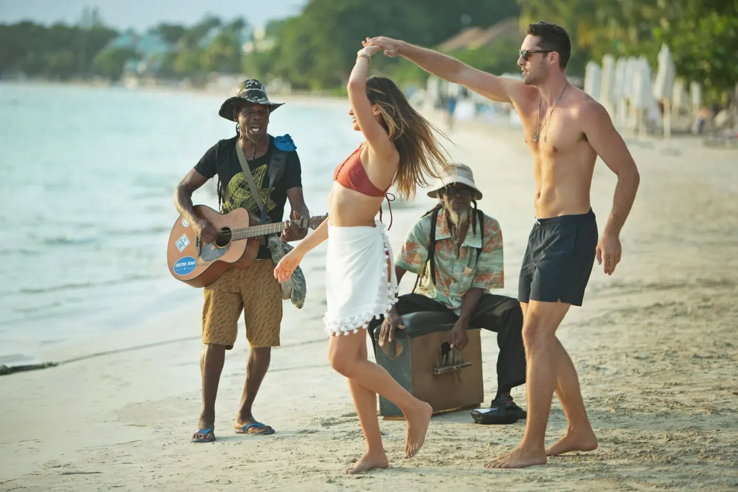 Guests dancing to live music on the beach at Azul Beach Resort Negril.