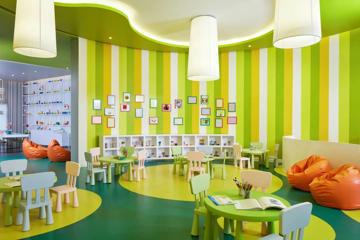 Colorful children's playroom with small tables and beanbags at Azul Beach Resort Negril.