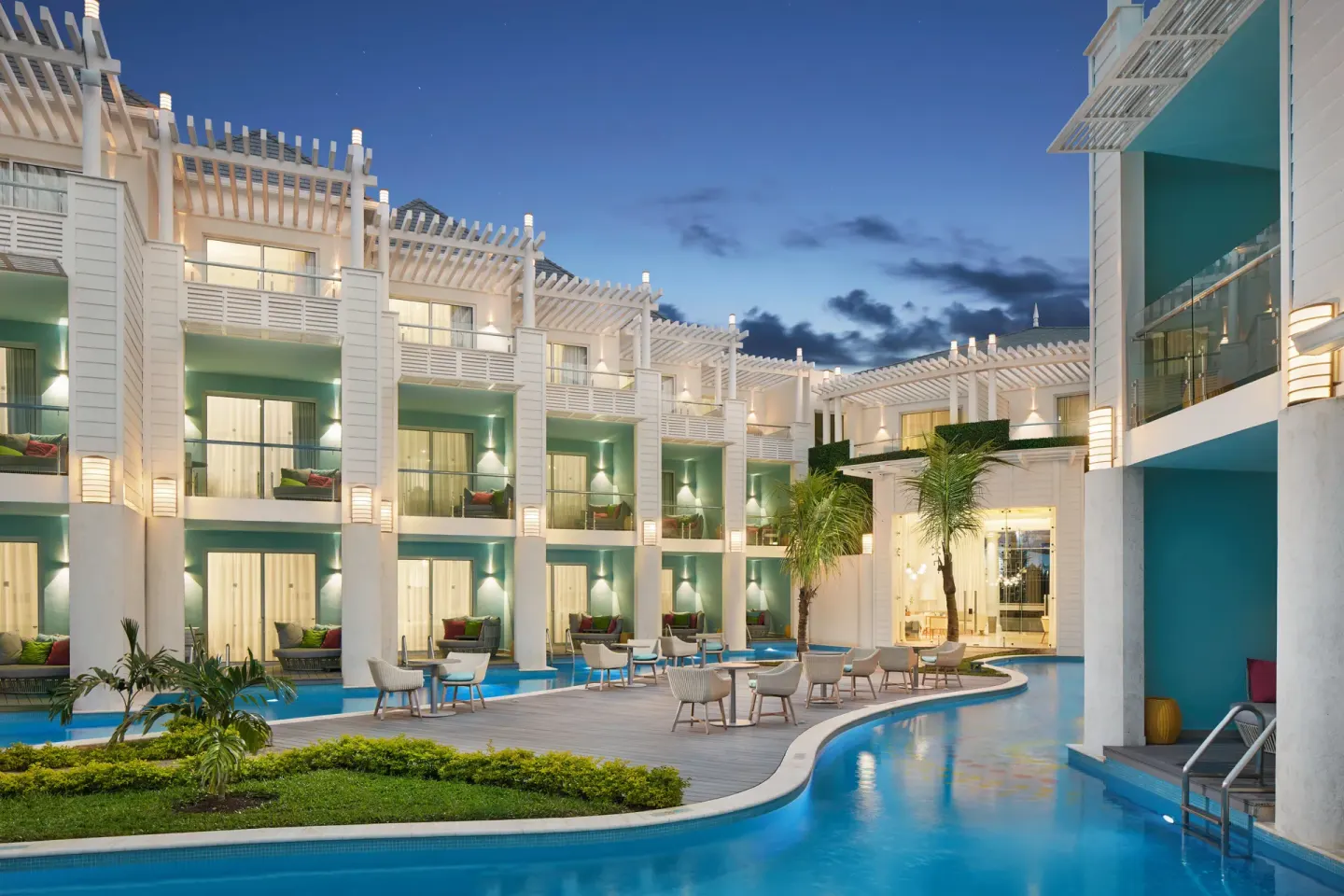 Illuminated swim-up suites and pool courtyard at Azul Beach Resort Negril.
