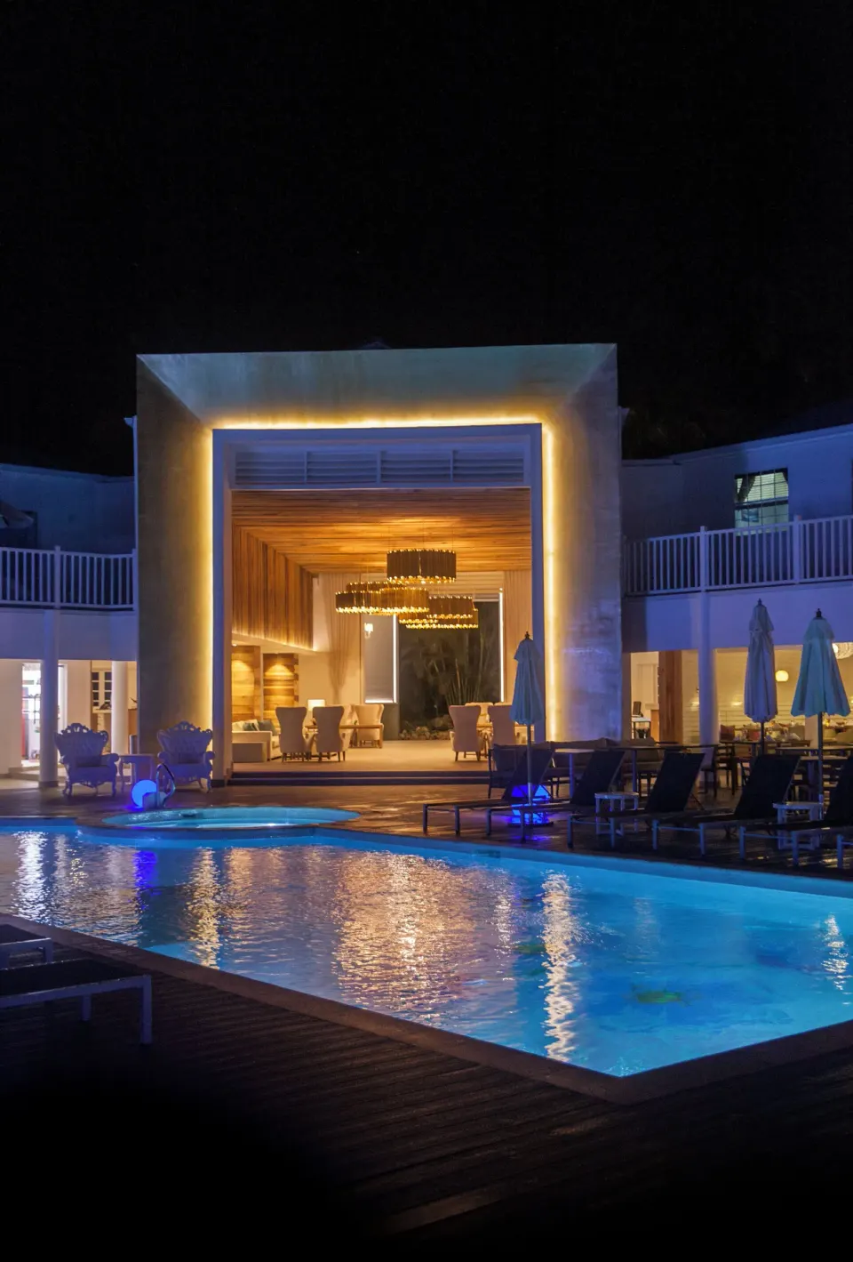 Nighttime pool and illuminated lobby entrance at Azul Beach Resort Negril.