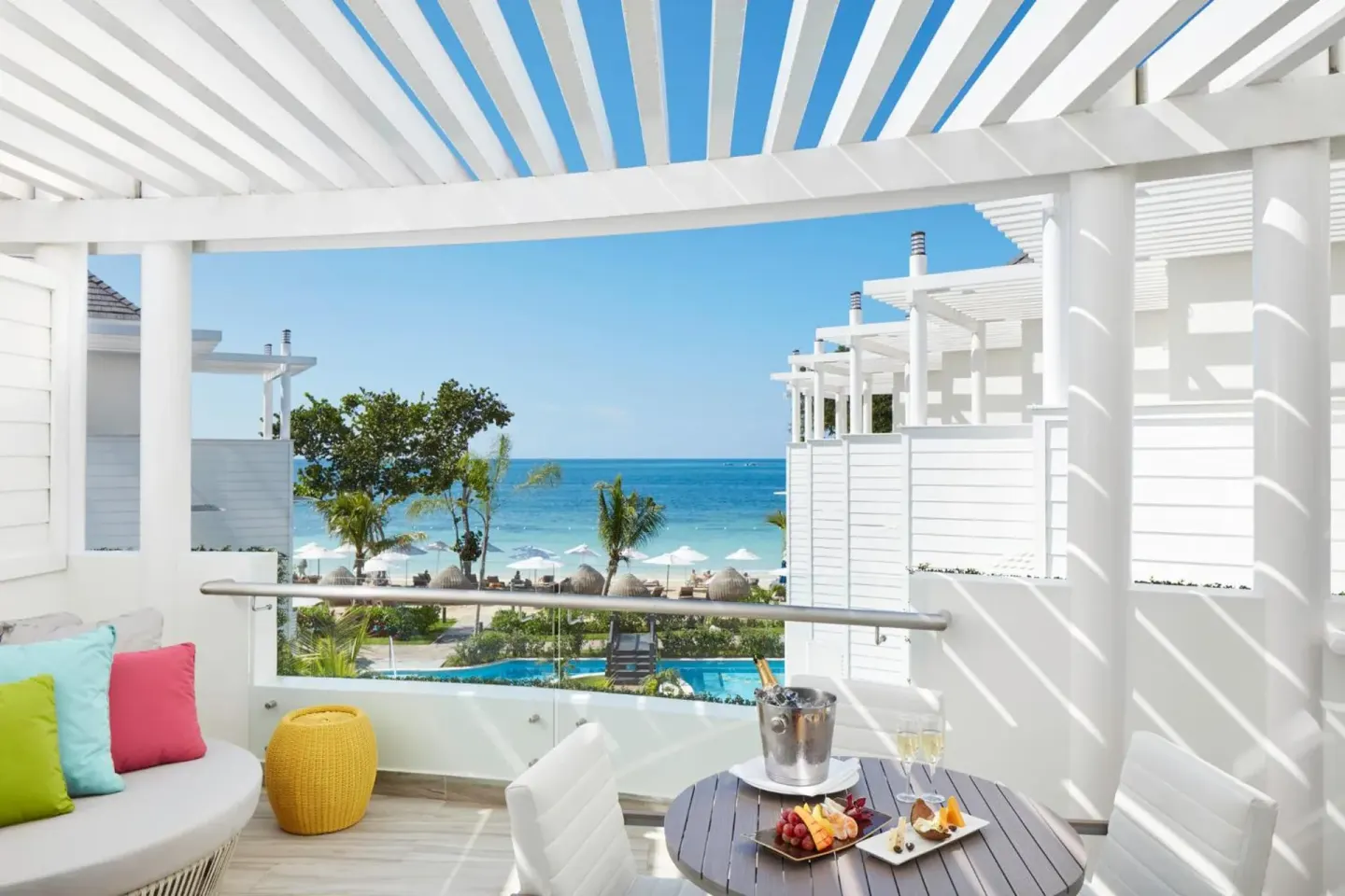 Ocean-view balcony with lounge seating and table at Azul Beach Resort Negril.