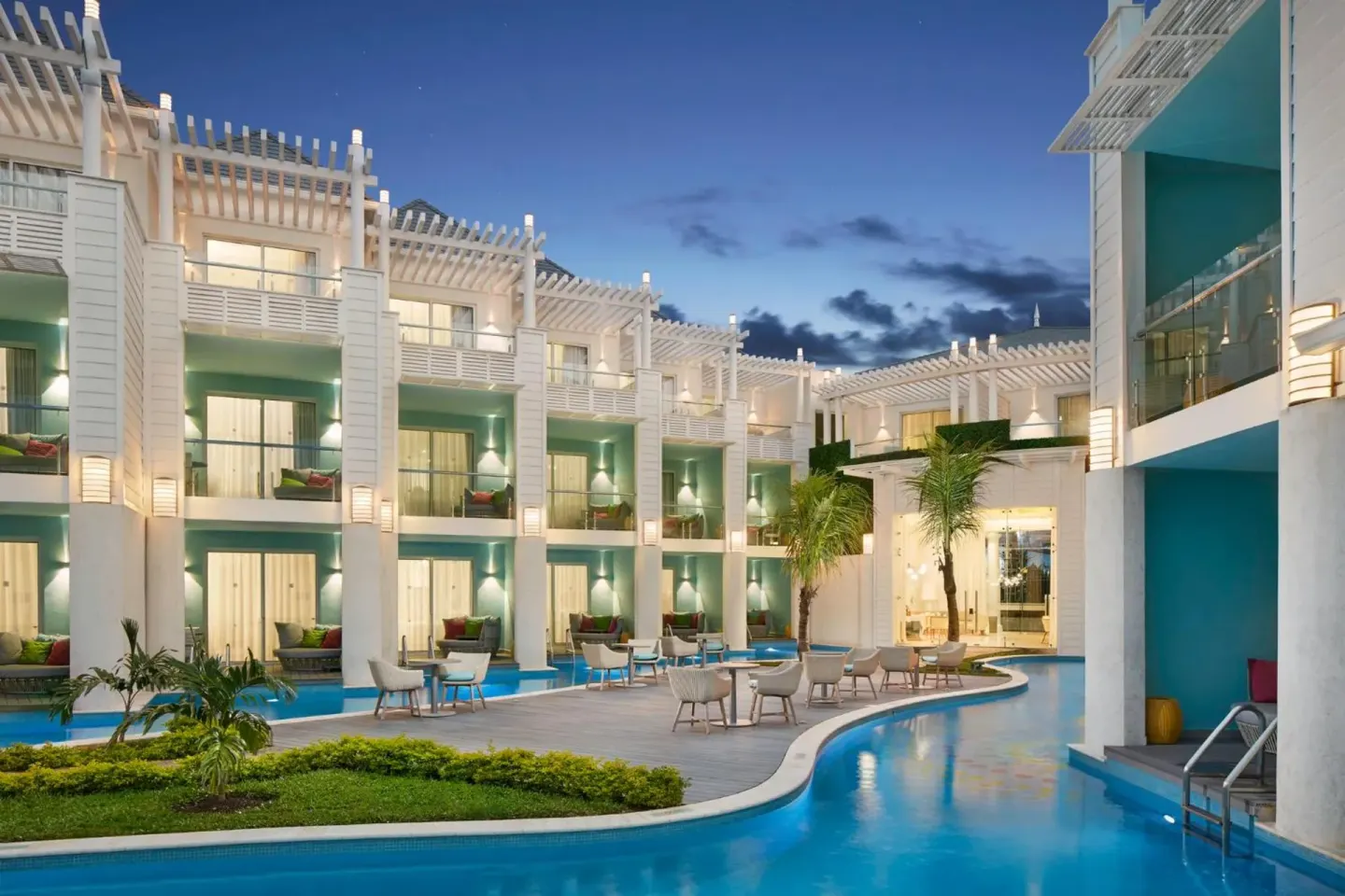 Evening swim-up suite pool area at Azul Beach Resort Negril with balconies, terraces and turquoise water.