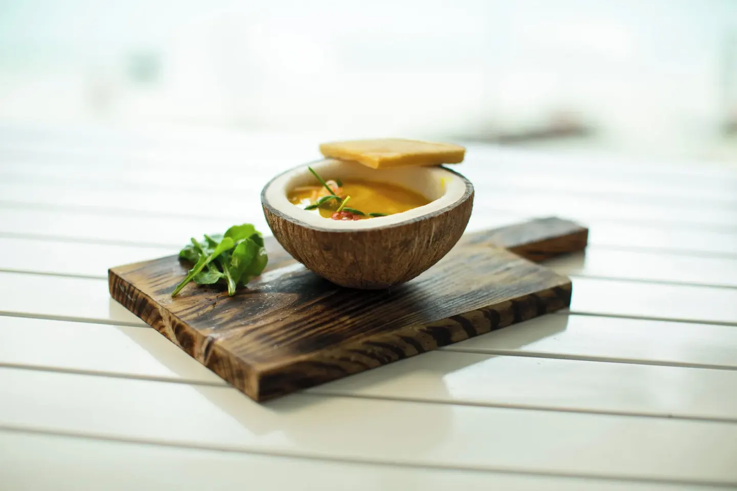 Coconut bowl appetizer on a wooden board at Azul Beach Resort Negril.