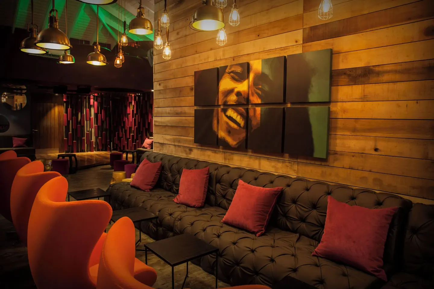 Lounge seating with portrait artwork and pendant lights at Azul Beach Resort Negril.