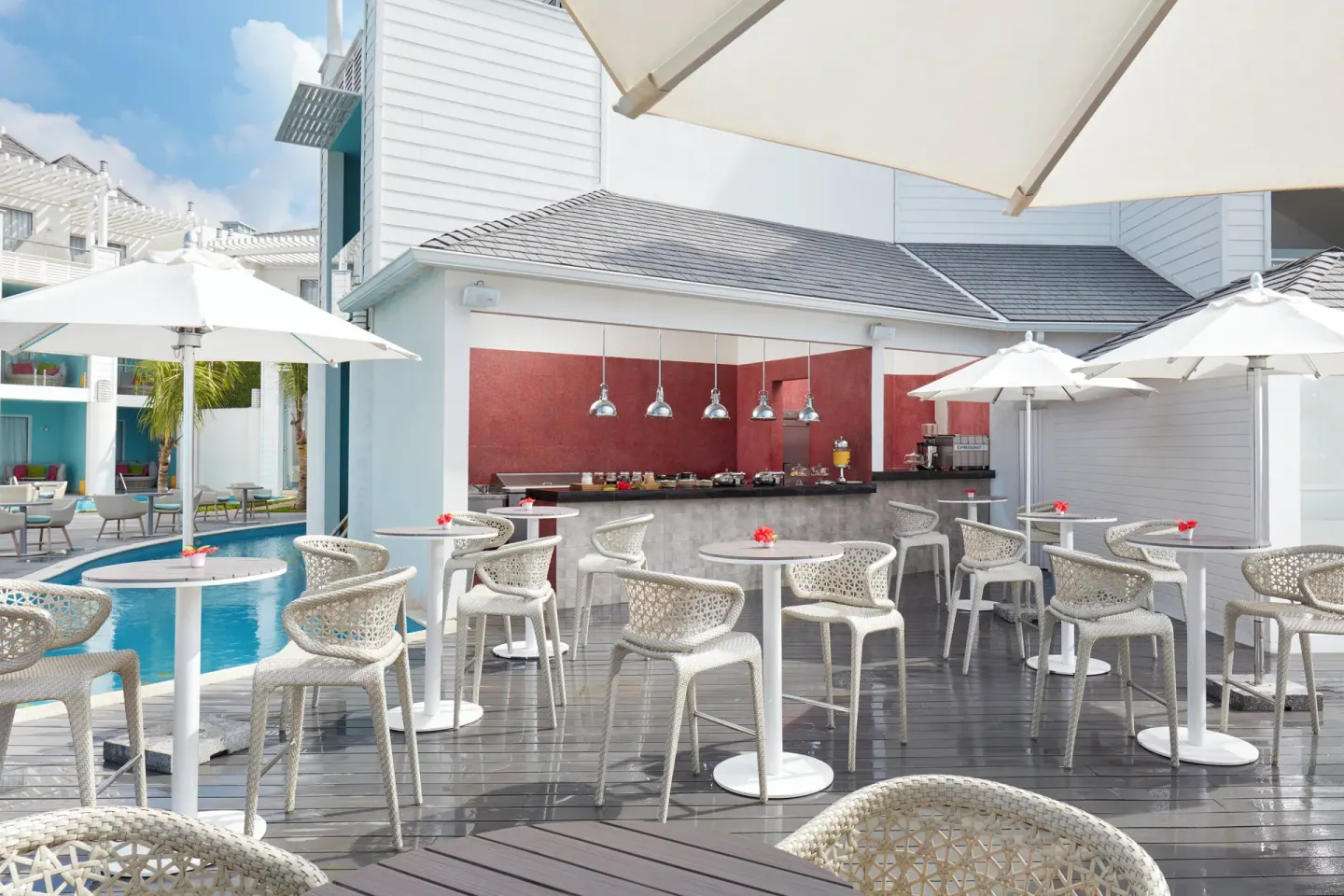 Poolside terrace with café counter and umbrellas at Azul Beach Resort Negril.