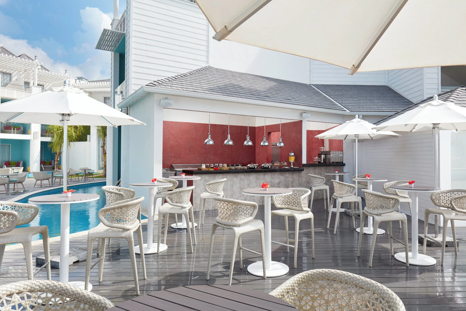 Poolside terrace with café counter and umbrellas at Azul Beach Resort Negril.