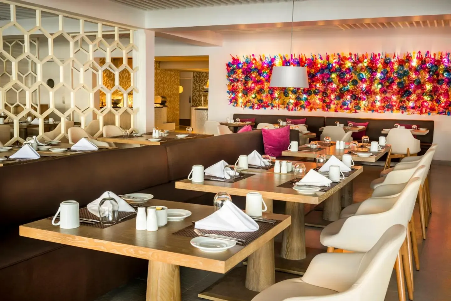 Restaurant dining room with colorful wall art at Azul Beach Resort Negril.