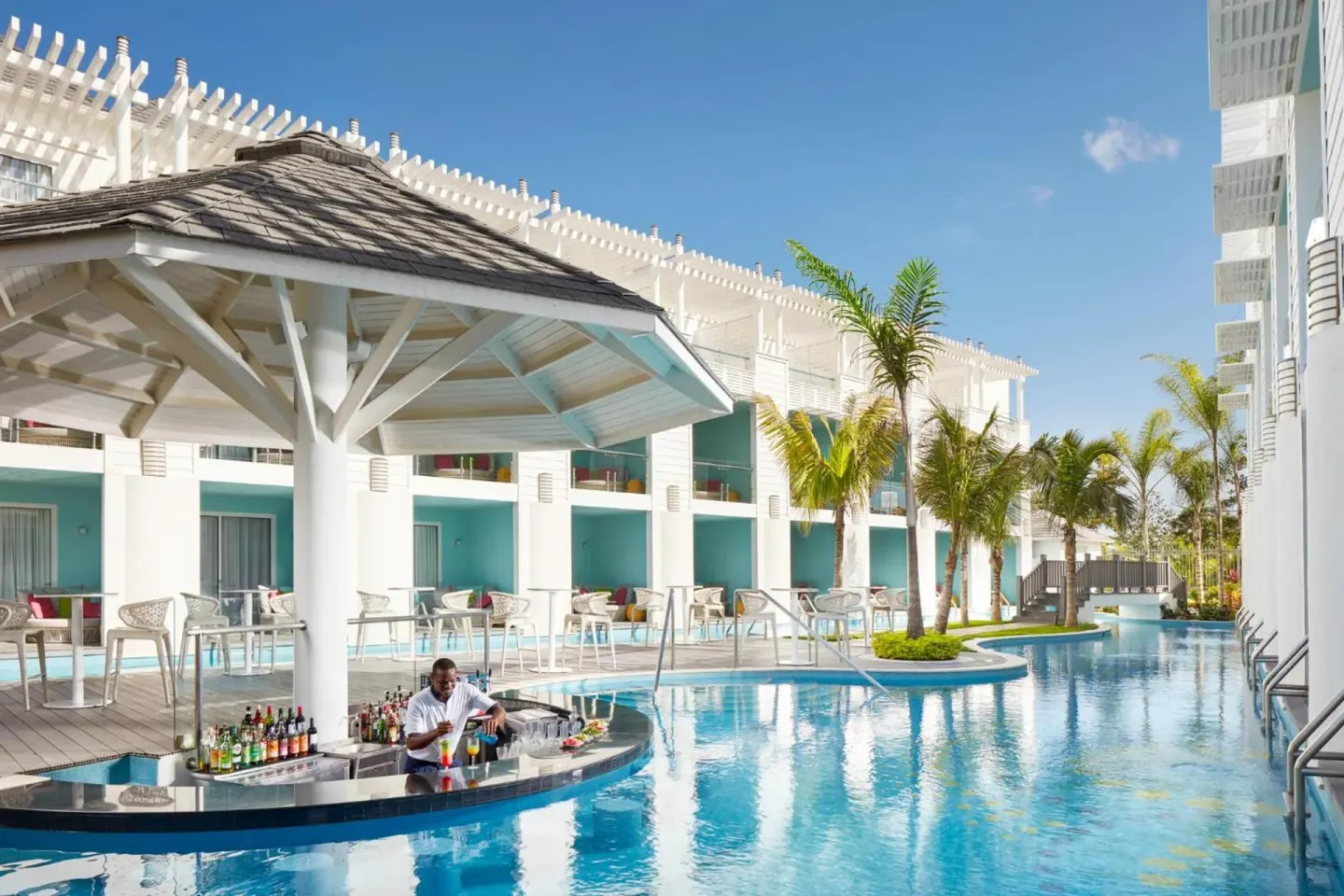 Swim-up bar and pool with palm trees at Azul Beach Resort Negril.