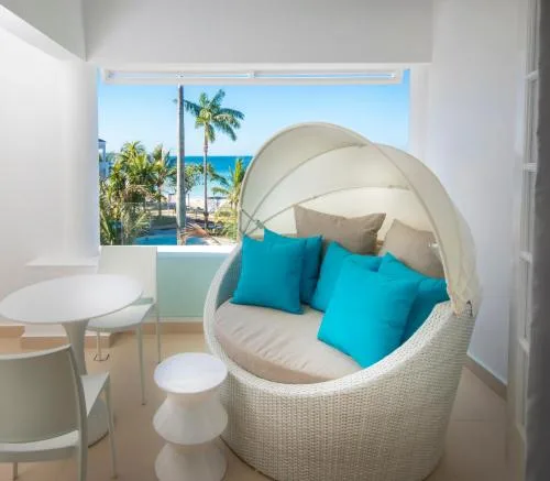Deluxe Swim Up Room balcony seating with canopy chair at Azul Beach Resort Negril.