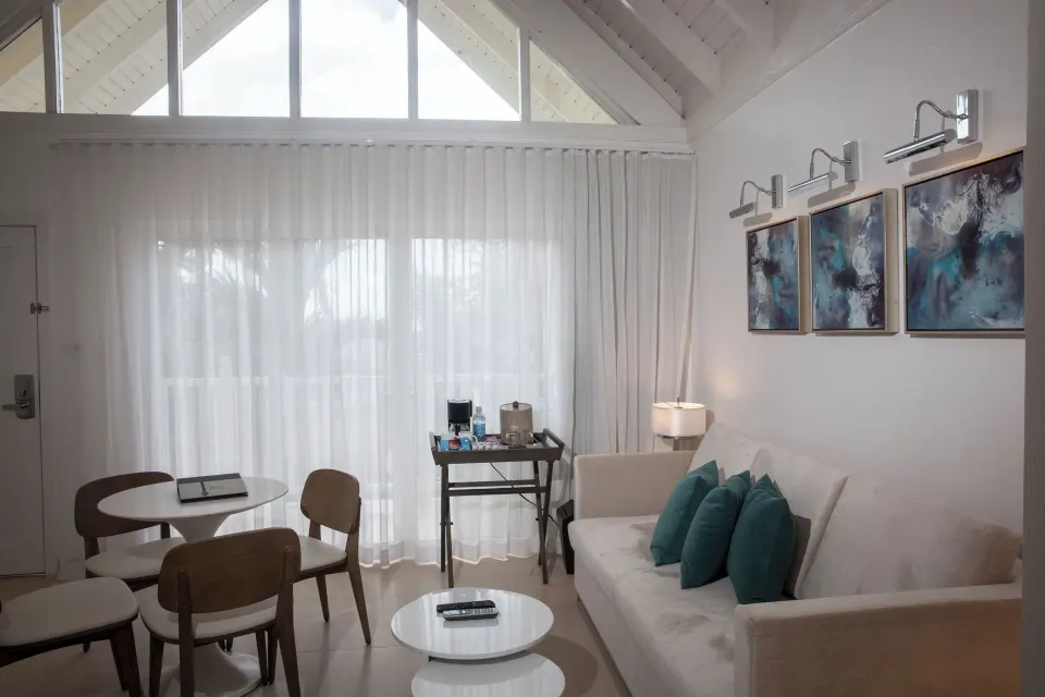 Loft family suite living area with sofa and dining table at Azul Beach Resort Negril.