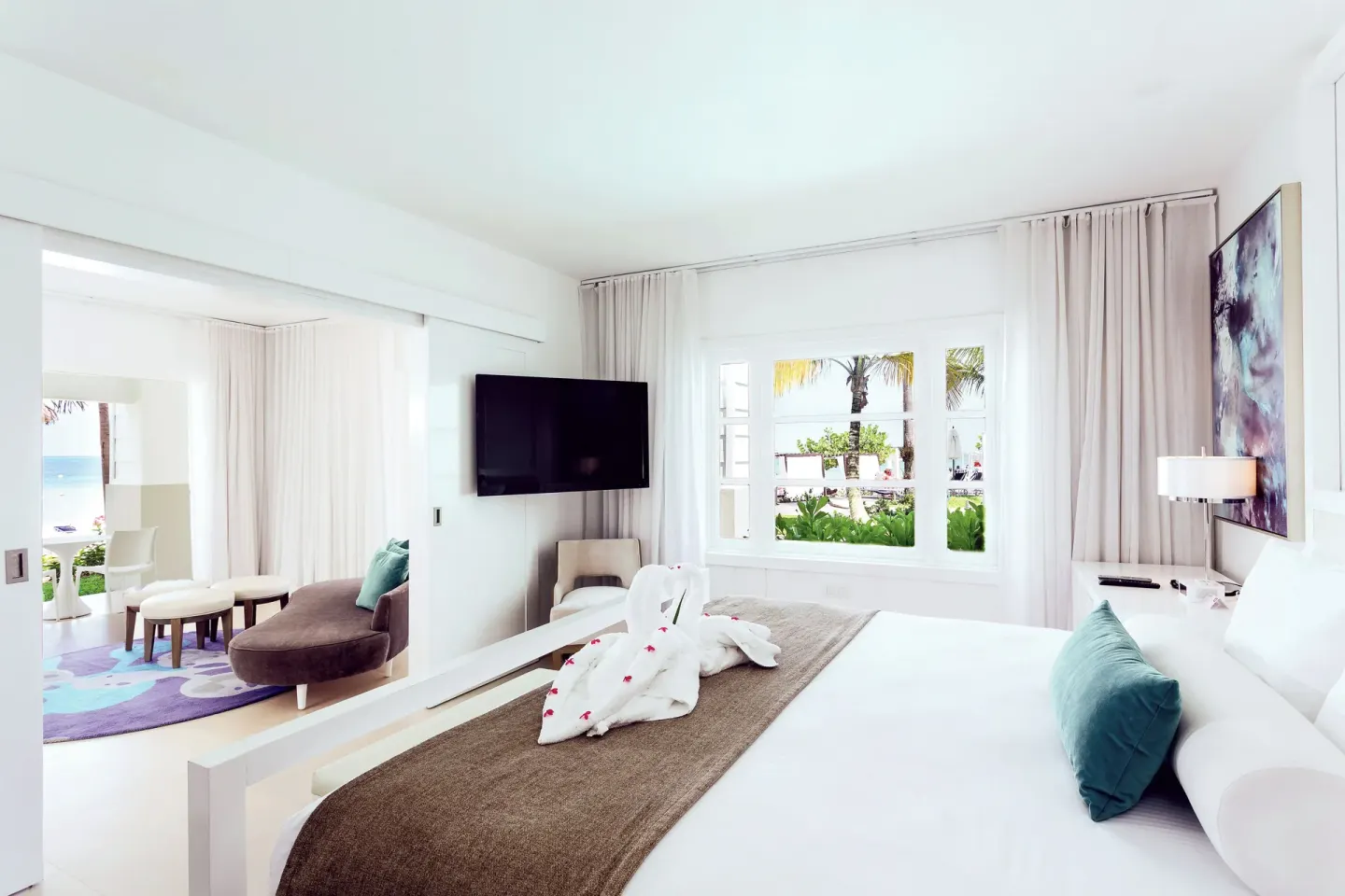 Honeymoon Suite Beachfront bedroom with king bed and seating area at Azul Beach Resort Negril.