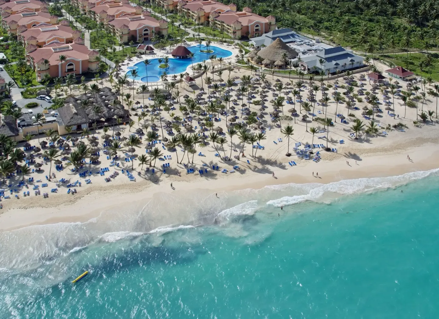 Aerial view of beach, pool, and resort buildings at Bahia Principe Escape Ambar.