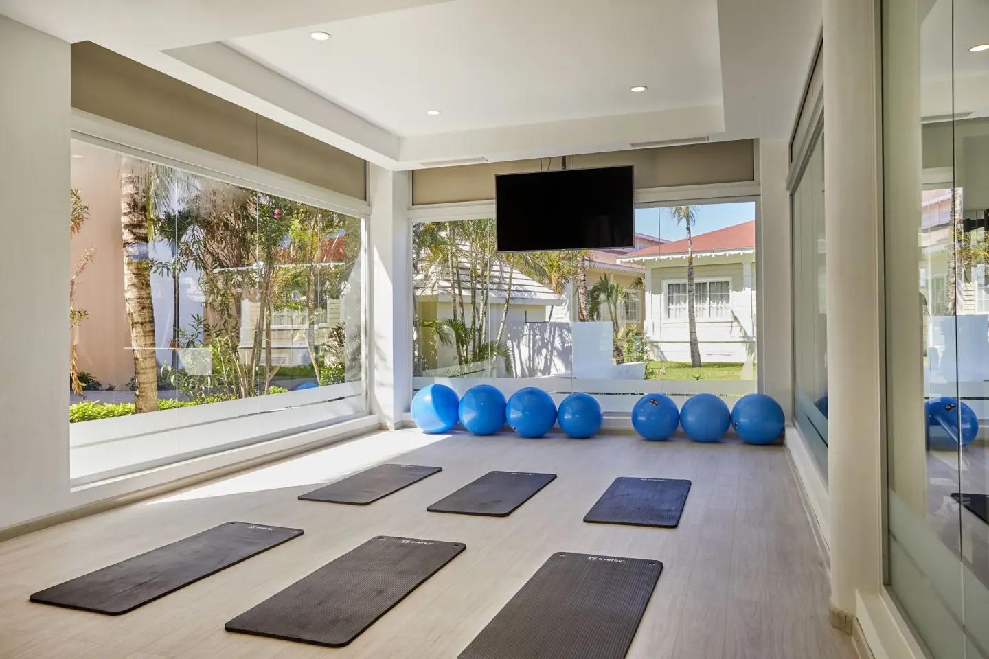 Exercise mats and blue stability balls in the gym at Bahia Principe Escape Ambar.