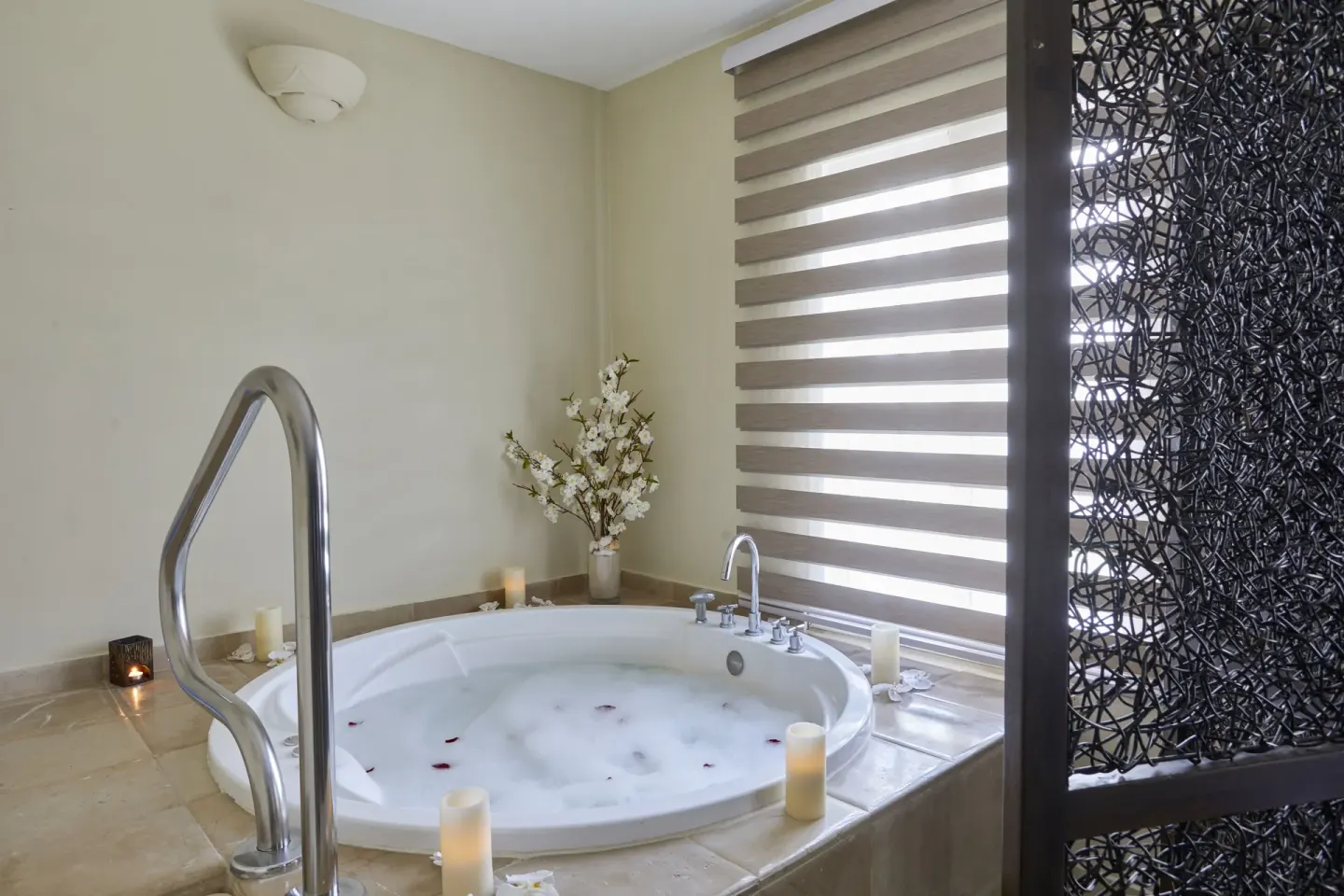 Indoor whirlpool tub with candles and flowers at Bahia Principe Escape Ambar.