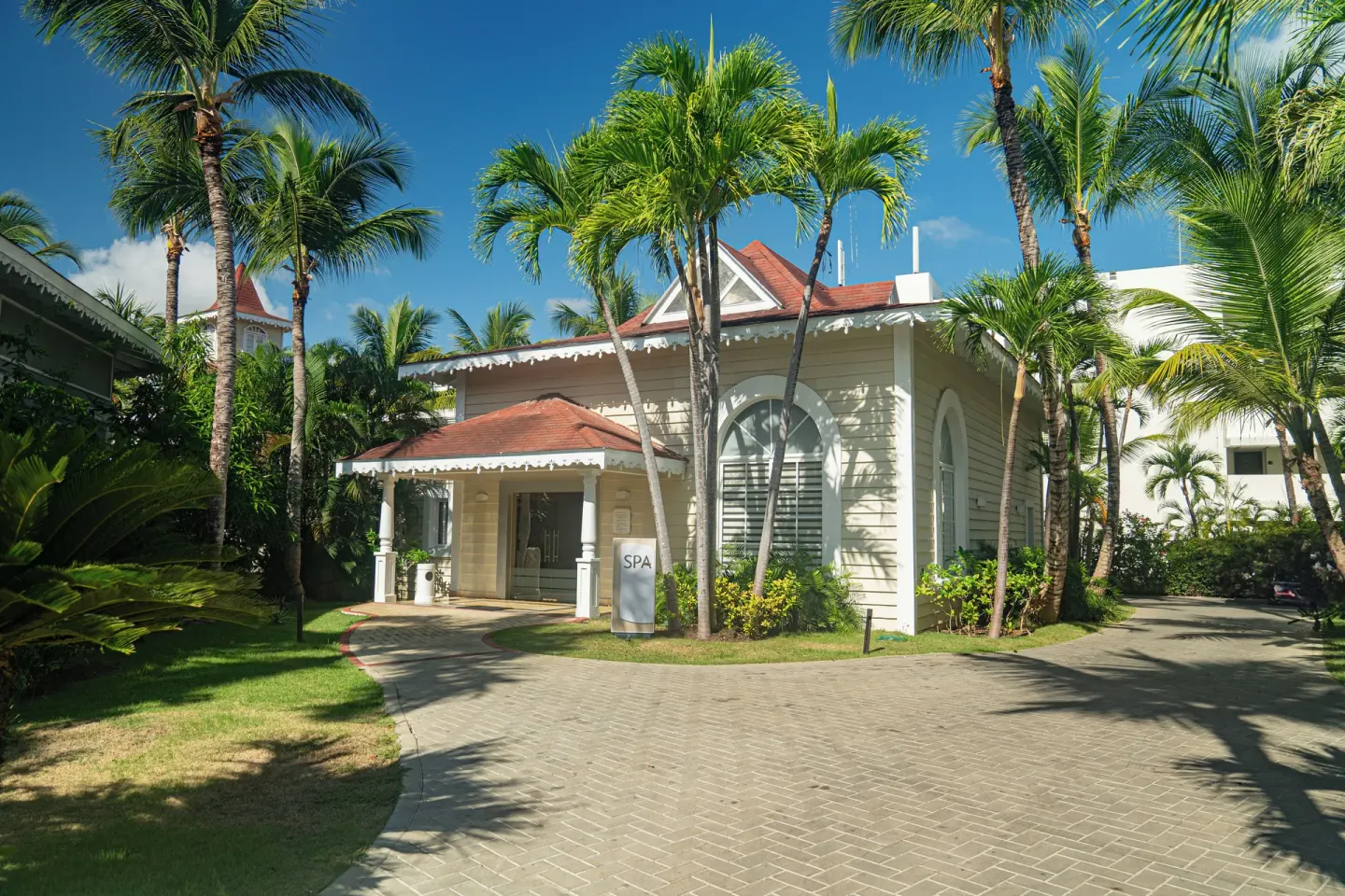Palm-lined spa building exterior at Bahia Principe Escape Ambar.